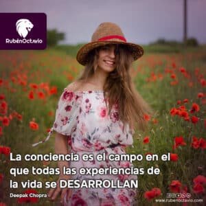 Mujer sonriendo en un campo de flores, representando la expansión de la conciencia y la claridad interna.
